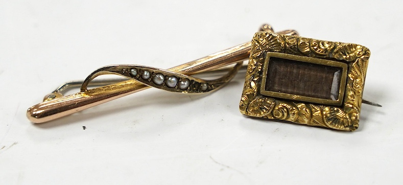 A Victorian gilt metal and plaited hair mourning brooch, 18mm and a yellow metal and seed pearl set bar brooch. Condition - poor